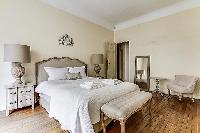 bedroom  with queen-sized bed, varying duvet colors and room wall decals in a 4-bedroom Paris luxury