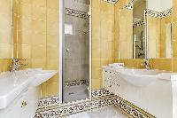 elegant en-suite bathroom with bathtub, lavatory, and full toilet in a 4-bedroom Paris luxury apartm
