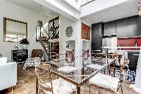 rectangular, glass table and seats for 4 people in a Paris luxury apartment