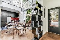 rectangular, glass table and seats for 4 people in a Paris luxury apartment