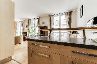 small countertop table with bar stools in a Paris luxury apartment