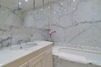 bathroom with marble lavatory and bathtub in a 5-bedroom paris luxury apartment