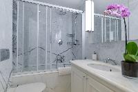 bathroom with marble lavatory, shower, toilet and bathtub in a 5-bedroom paris luxury apartment