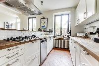 modern fully-equipped kitchen with ample closets and drawers in a 4-bedroom Paris luxury apartment