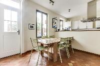 modern fully-equipped kitchen with ample closets and drawers, and a coffee or breakfast table in a 4