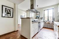 modern fully-equipped kitchen with ample closets and drawers in a 4-bedroom Paris luxury apartment