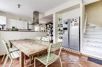 modern fully-equipped kitchen with ample closets and drawers, and a coffee or breakfast table in a 4