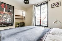 master bedroom with a king-size bed and a full en suite bathroom in a 4-bedroom Paris luxury apartme
