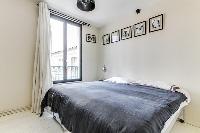 cozy bedroom with a queen size bed in a Paris luxury apartment