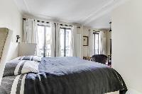 master bedroom with a king-size bed and a full en suite bathroom in a 4-bedroom Paris luxury apartme