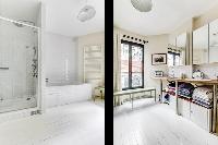 spacious well-maintained and neat bathroom with bathtub, shower and sinks in a 4-bedroom Paris luxur