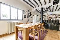 lovely dining area with a sturdy wooden dining table with seats and exposed beams in a 4-bedroom Par